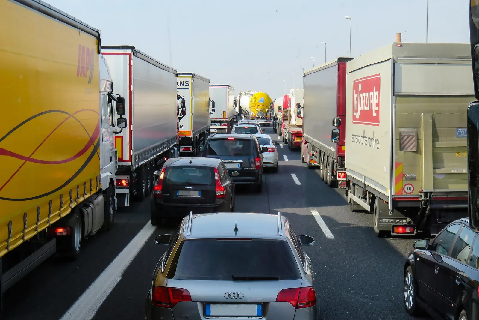 Motorway traffic at a standstill, trucks and cars in every lane.